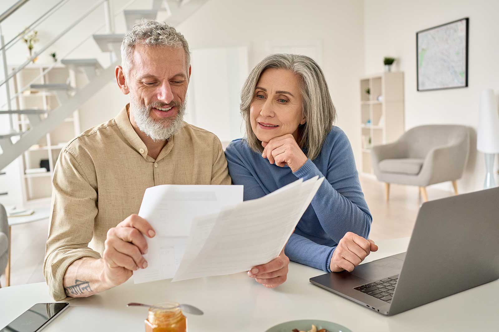 Older couple reviewing mortgage statement at home